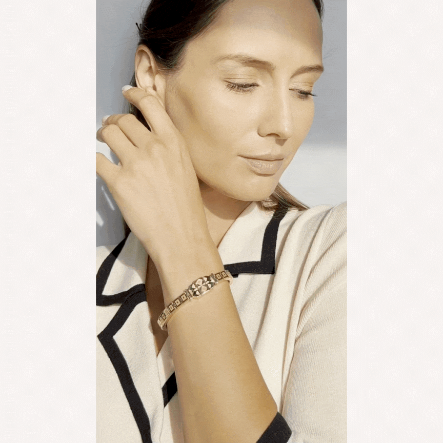 Place your hand on the bracelet and watch it lift and wrap itself around your hand, all by mechanical ingenuity.